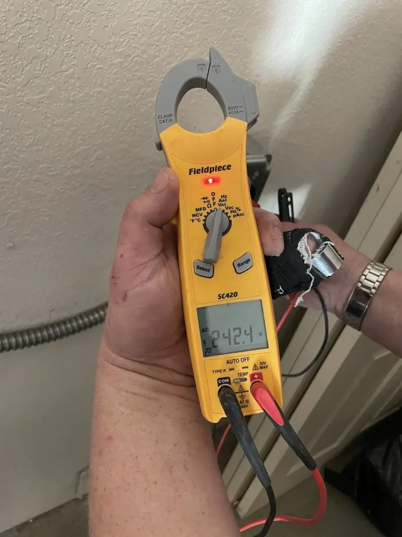 Voltage testing with clamp meter during Electrical Installation Services in New Brunswick